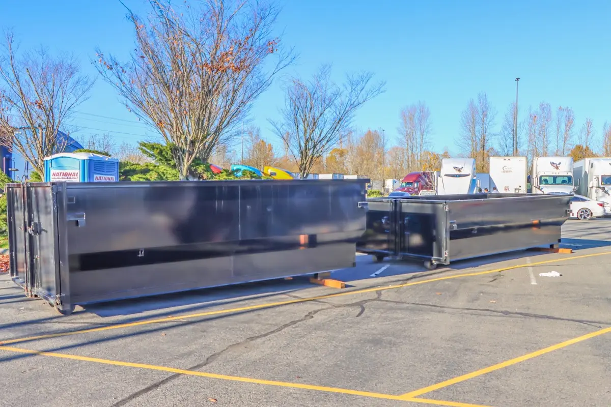 Professional dumpster rental service with roll-off container on residential driveway in Edgewater